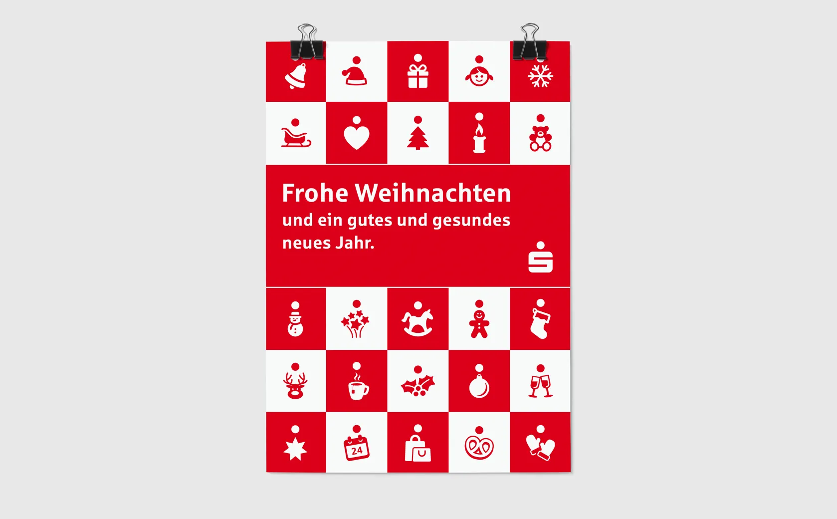 Aufgehängtes Weihnachtsplakat der Sparkasse Koblenz mit Piktogrammraster und rotem Grußfeld